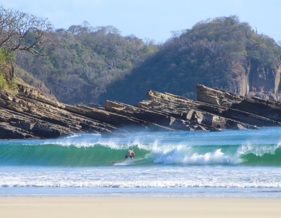 Offshore wind grooming a Pacific beach break at sunrise