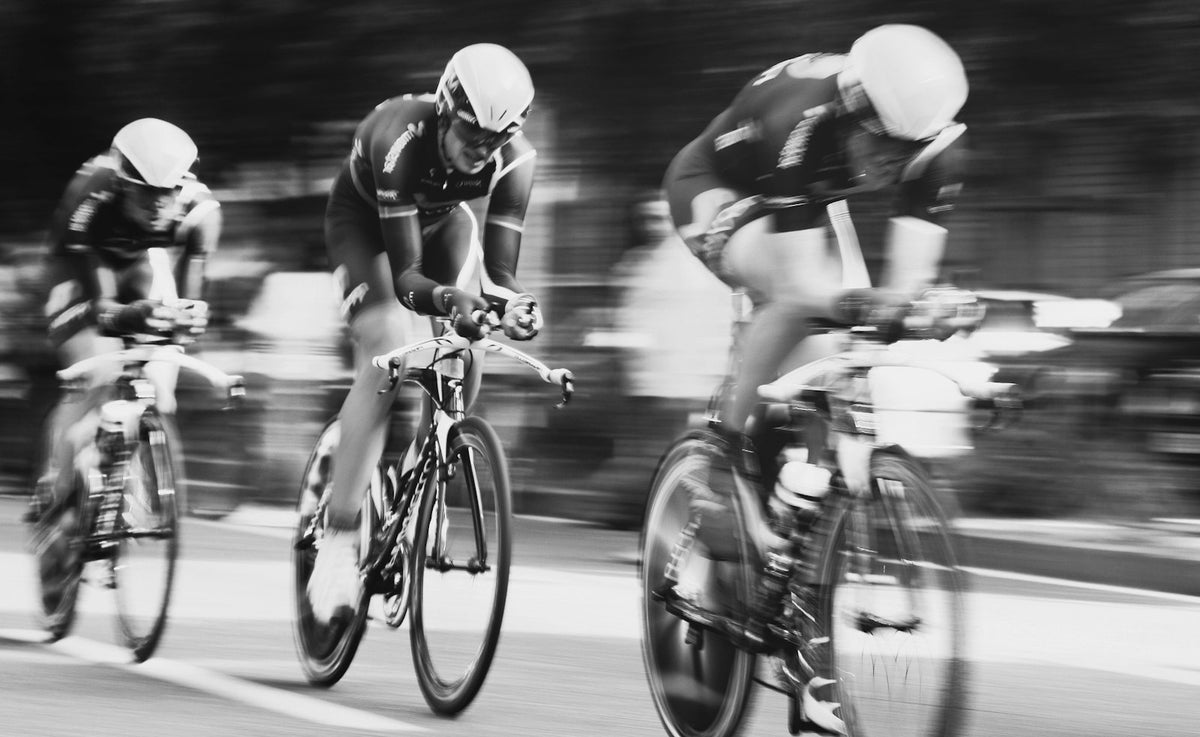 Three cyclists riding at speed