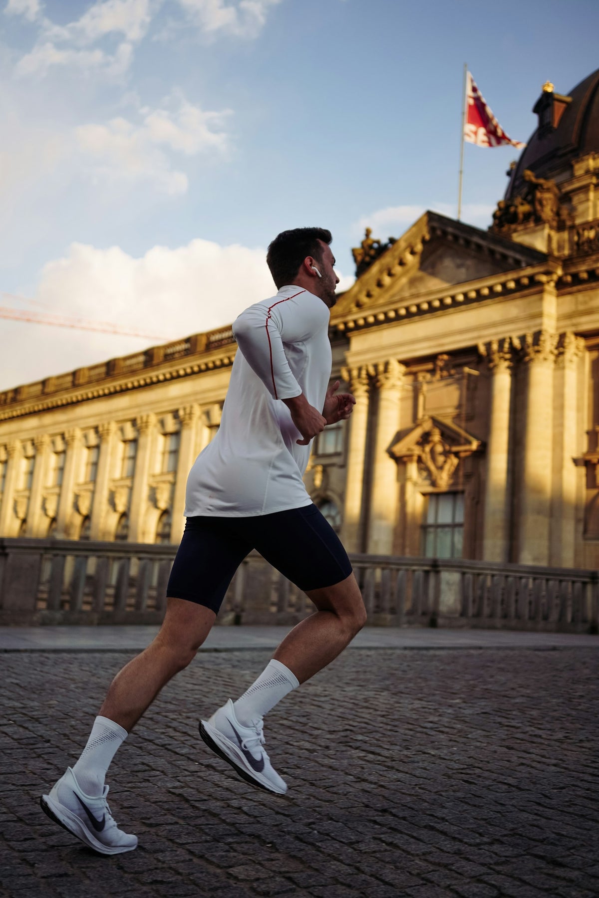 Runner passing a concrete building