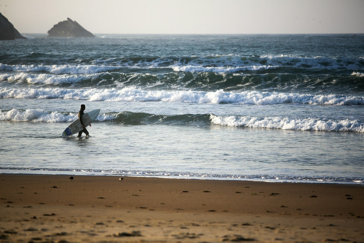 Surfer riding a wave at Peniche, Portugal
