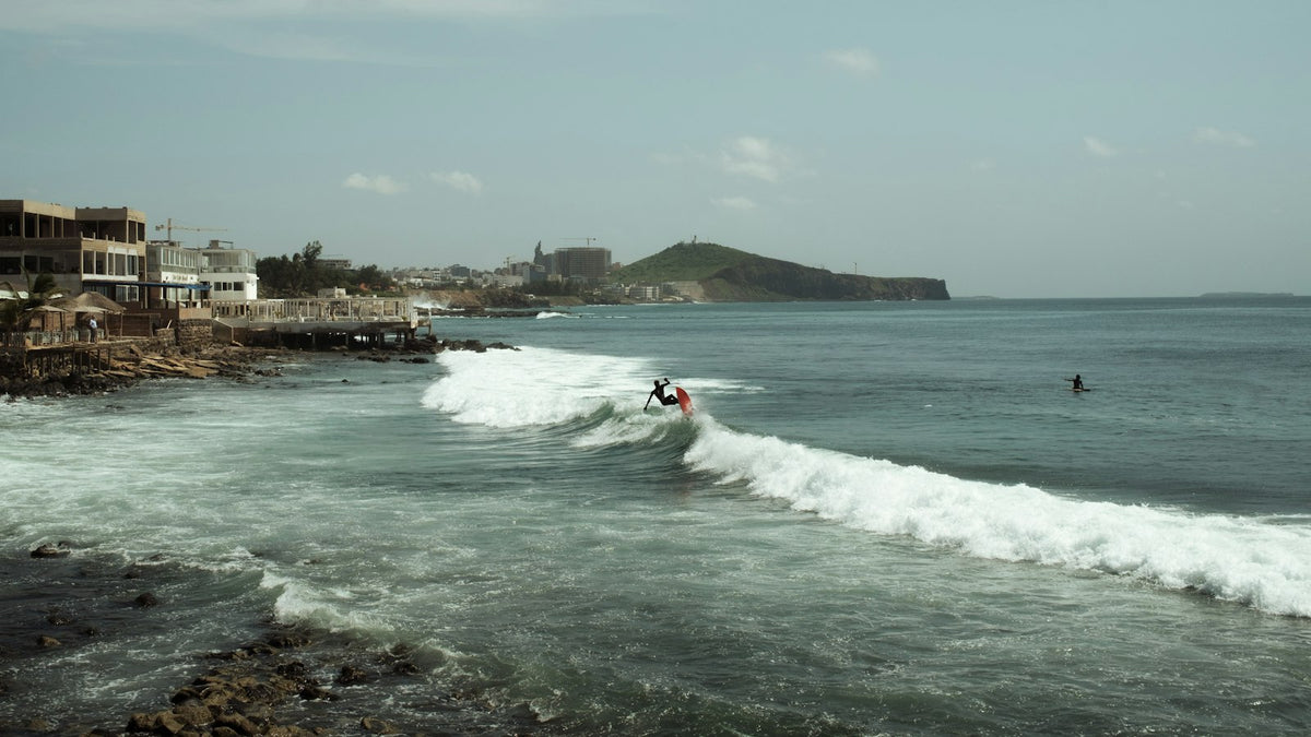 Surfer riding a wave in Dakar, Senegal
