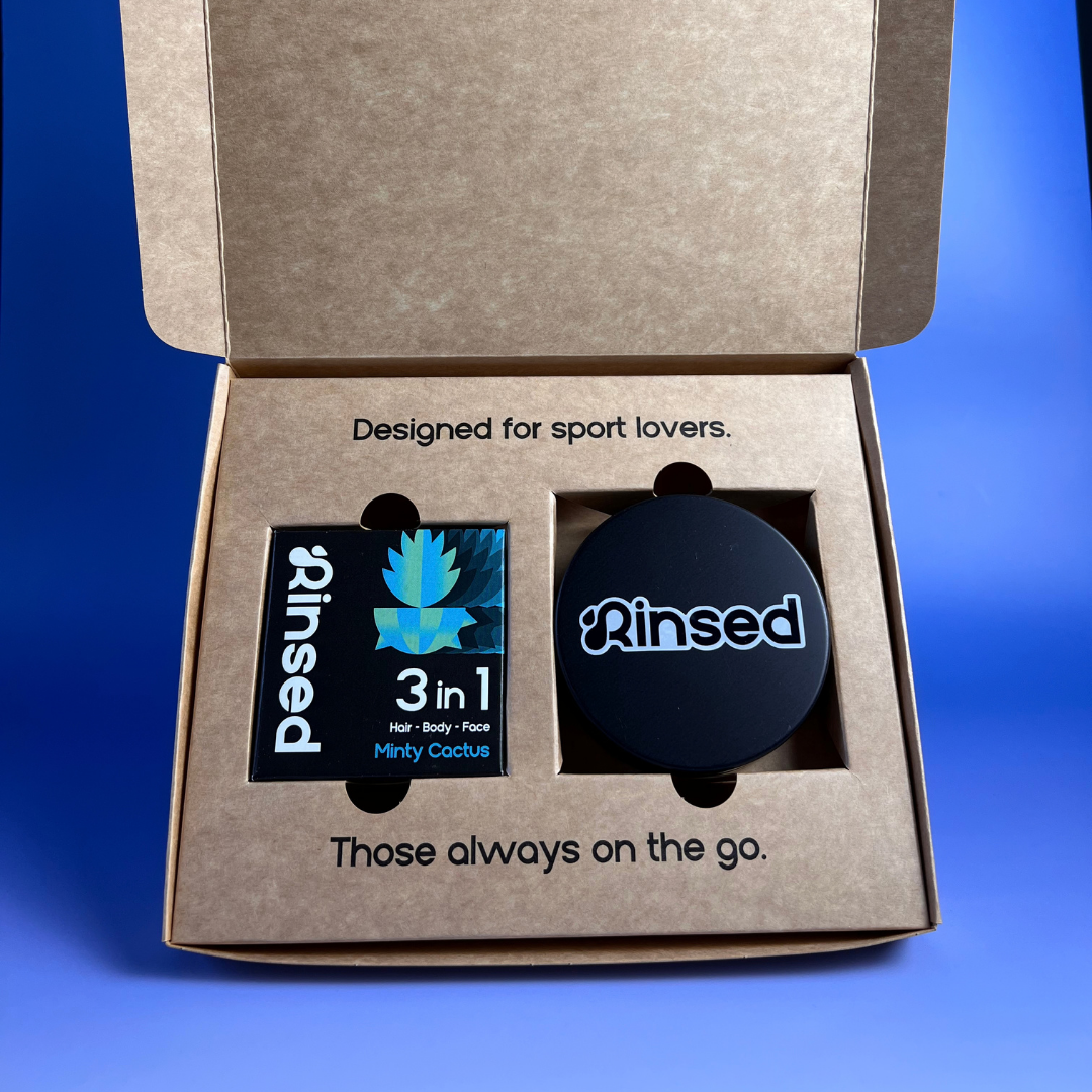 Open Rinsed™ gift box with a boxed Minty Cactus 3-in-1 bar and a black metal travel case
