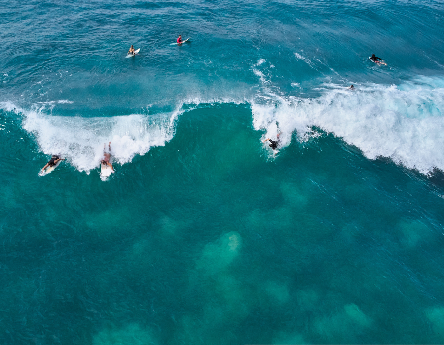Surfers waiting for waves in the lineup at Midigama, Sri Lanka