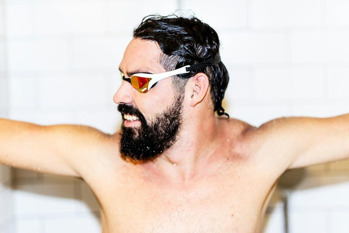Swimmer wearing white swim goggles