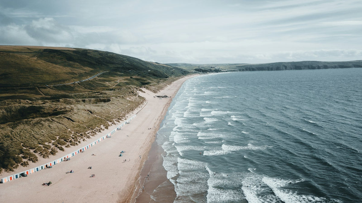 Aerial view of people on Woolacombe beach at high tide