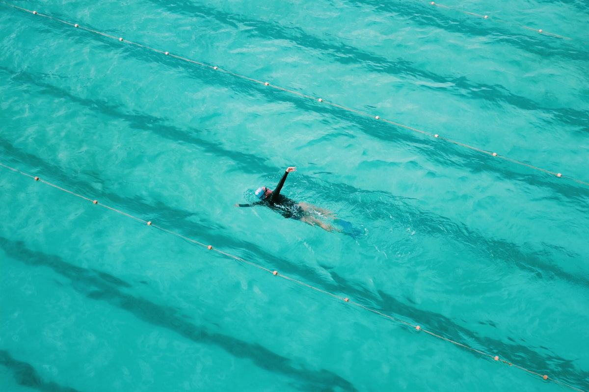 Swimmer mid-stroke in a pool