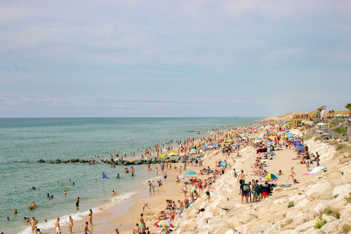 View of the beach at Lacanau, France, with a large group of people on the sand