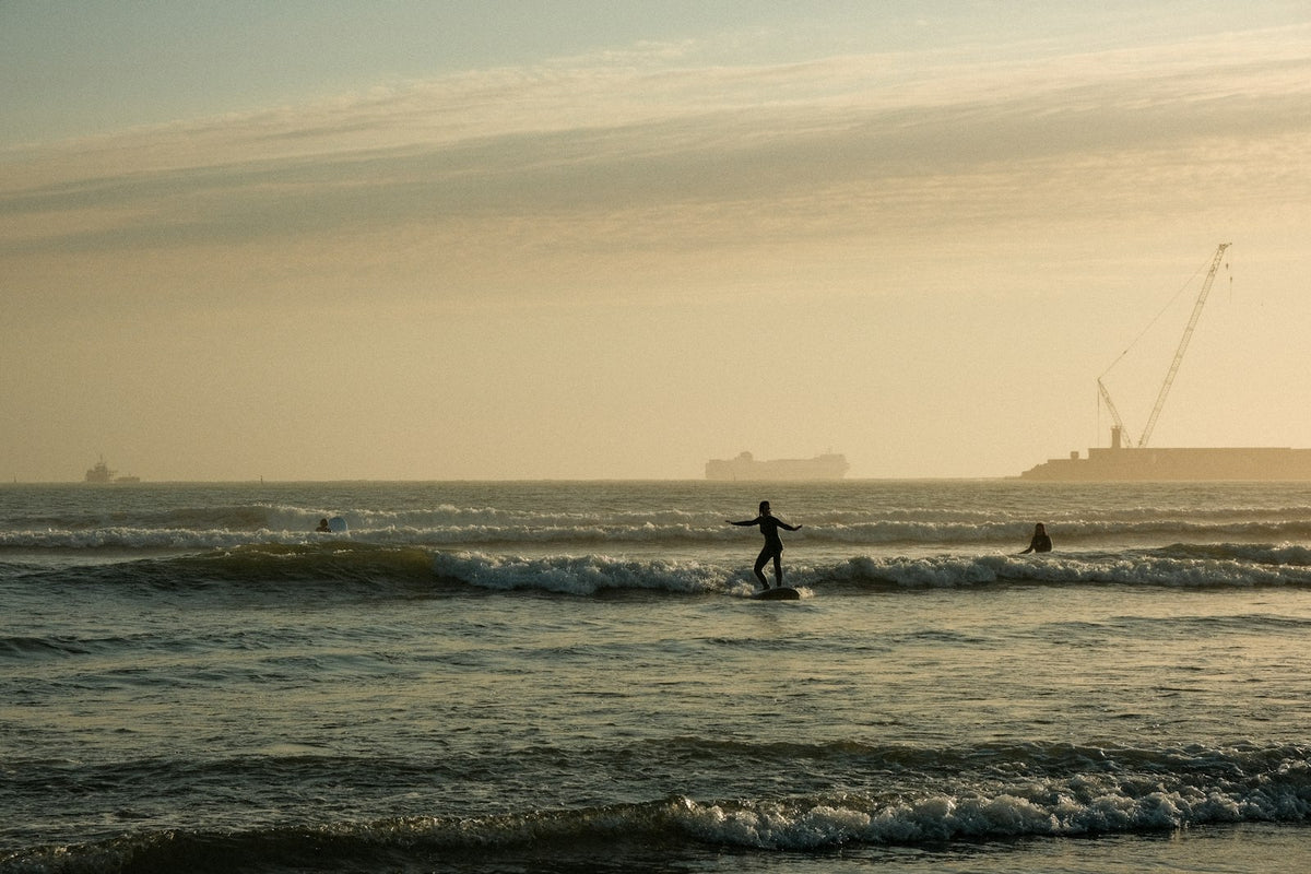A group of people surfing in the sea at Matosinhos, Portugal