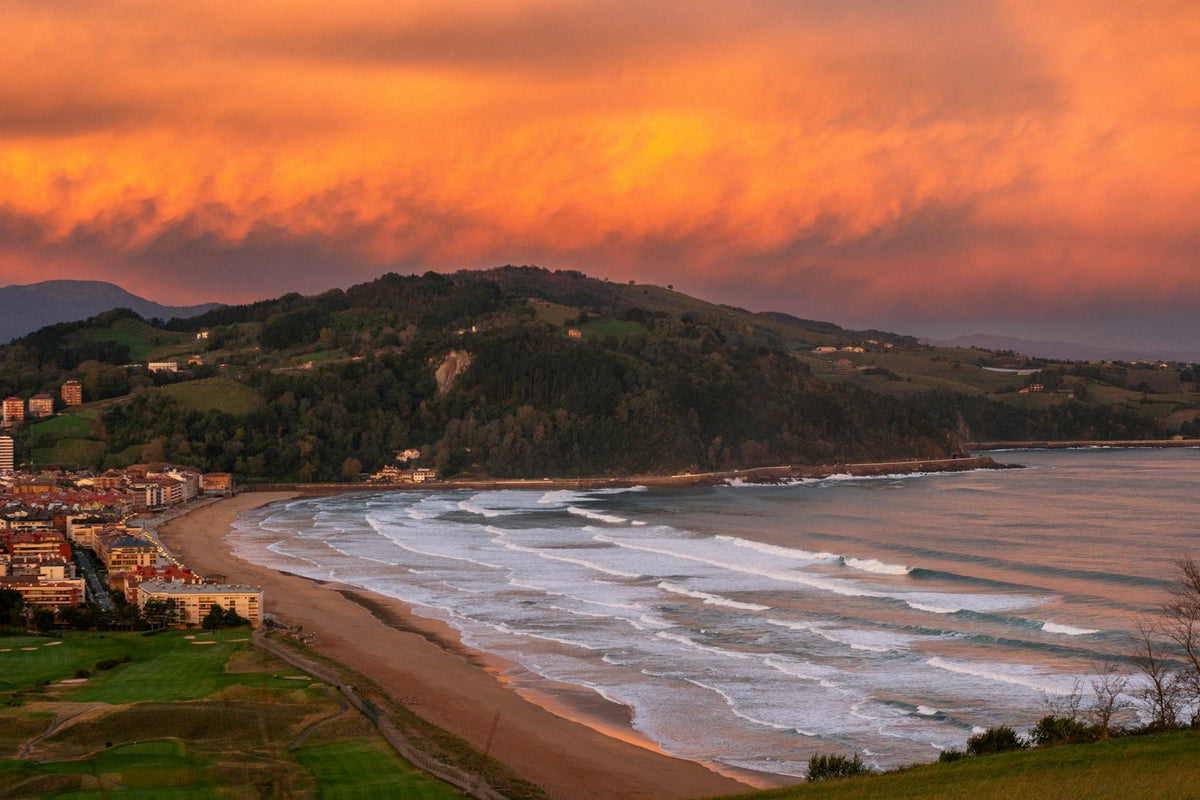 A view of a beach and a city at sunset in Zarautz, Spain
