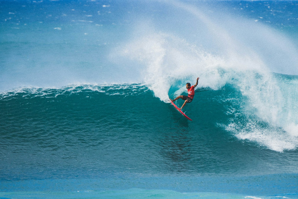 Surfer doing a turn on a wave at Sunset Beach on the North Shore of Oahu, Hawaii