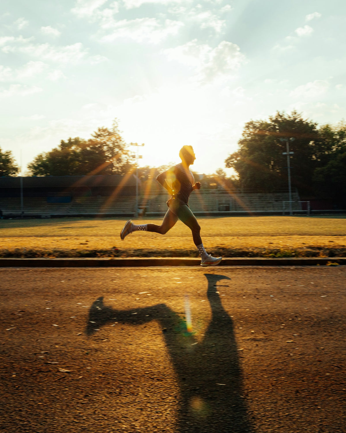 Runner on a track in golden sunlight