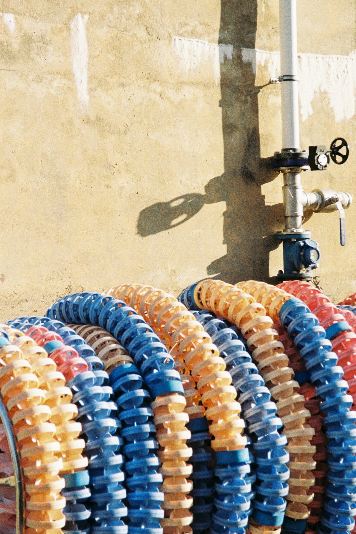 Swimming lane ropes coiled against a wall