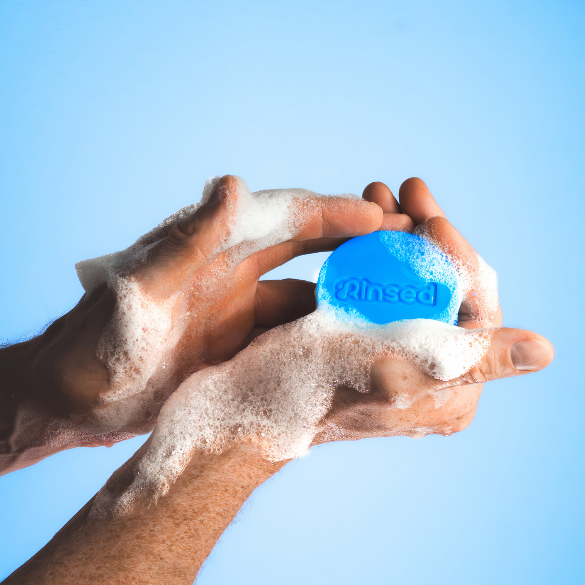 Hands lathering a Rinsed 3-in-1 bar