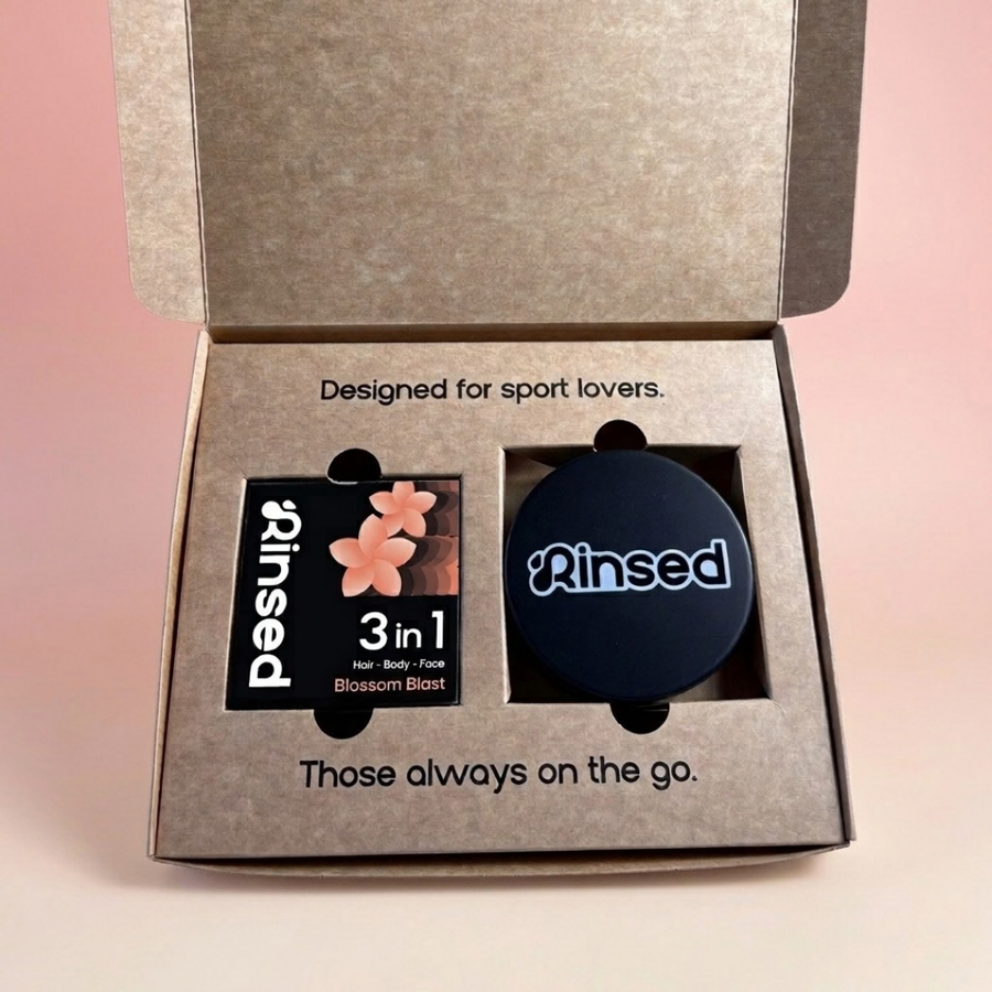 Open Rinsed™ gift box with a boxed Blossom Blast 3-in-1 bar and a black metal travel case