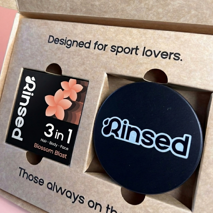 Close-up of the Blossom Blast bar box and black Rinsed™ travel case inside the gift box