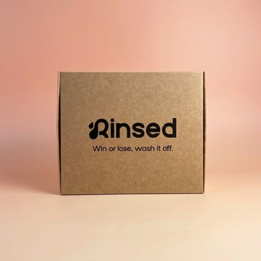 Closed kraft Rinsed™ gift box with the line Win or lose, wash it off, on a pink background