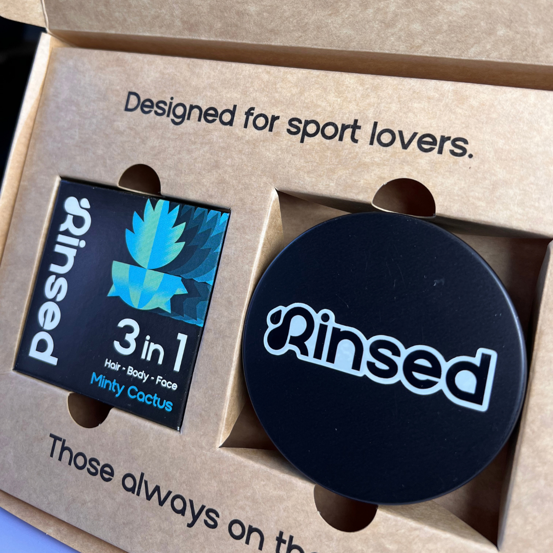 Close-up of the Minty Cactus bar box and black Rinsed™ travel case inside the gift box