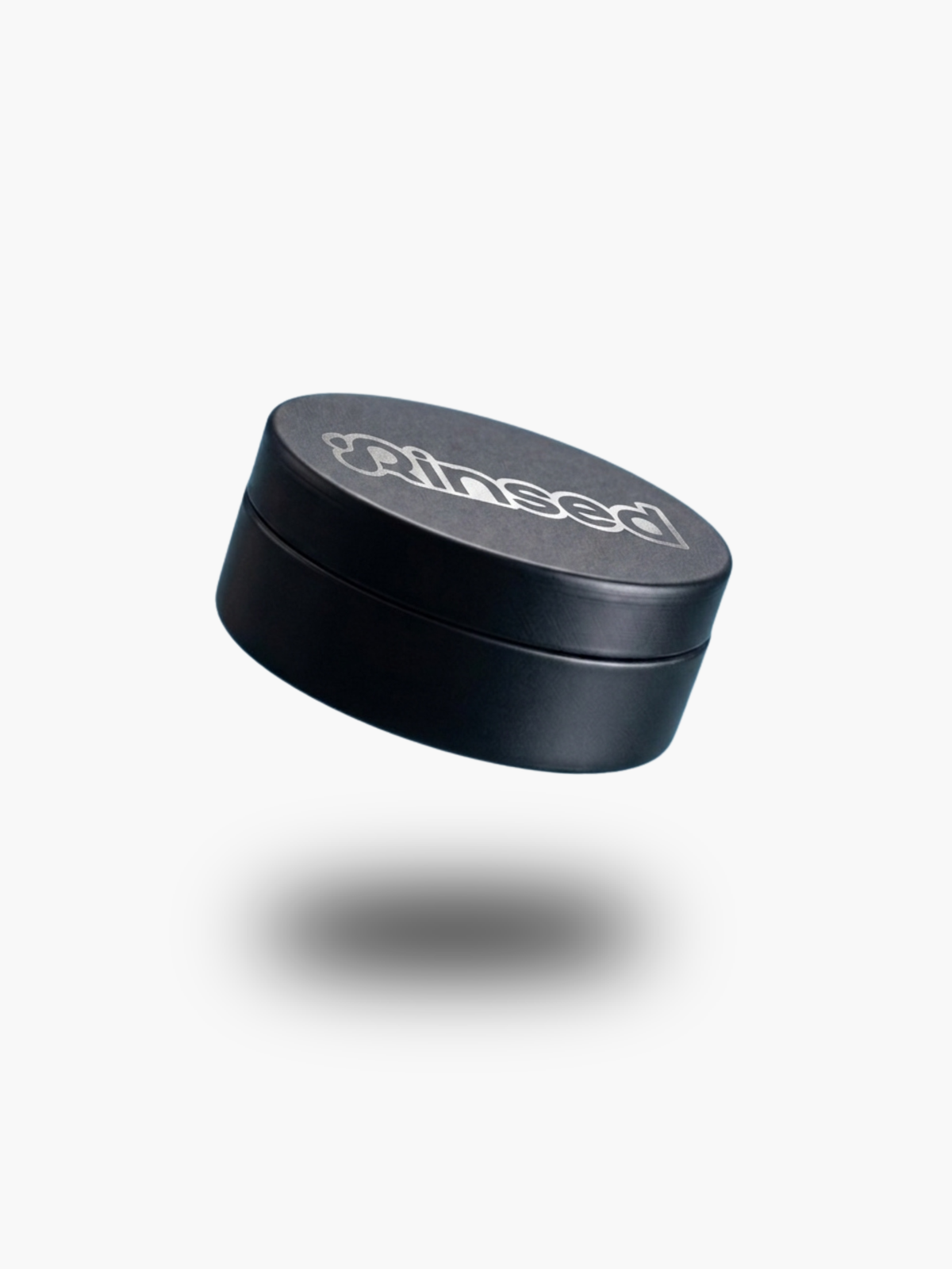 Closed black Rinsed™ metal travel case with the Rinsed logo on the lid